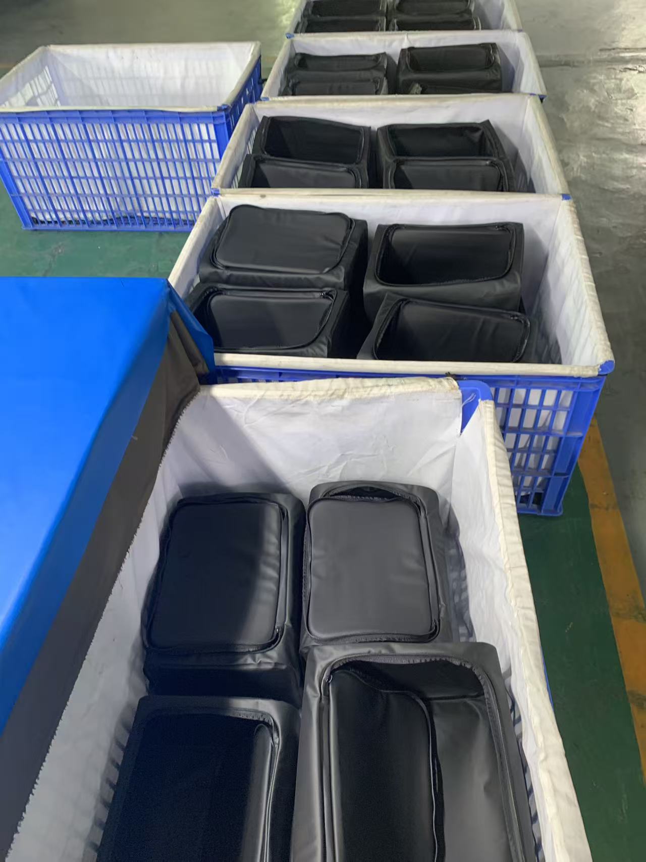 Finished soft coolers packed into fabric-lined crates for shipment
