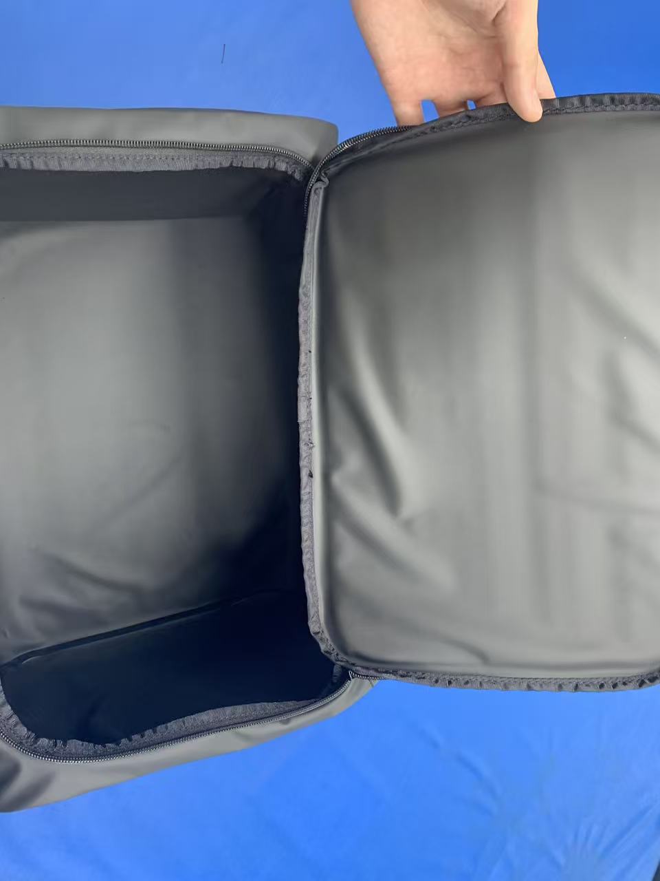 Interior of a soft cooler showing the glossy black food-grade liner